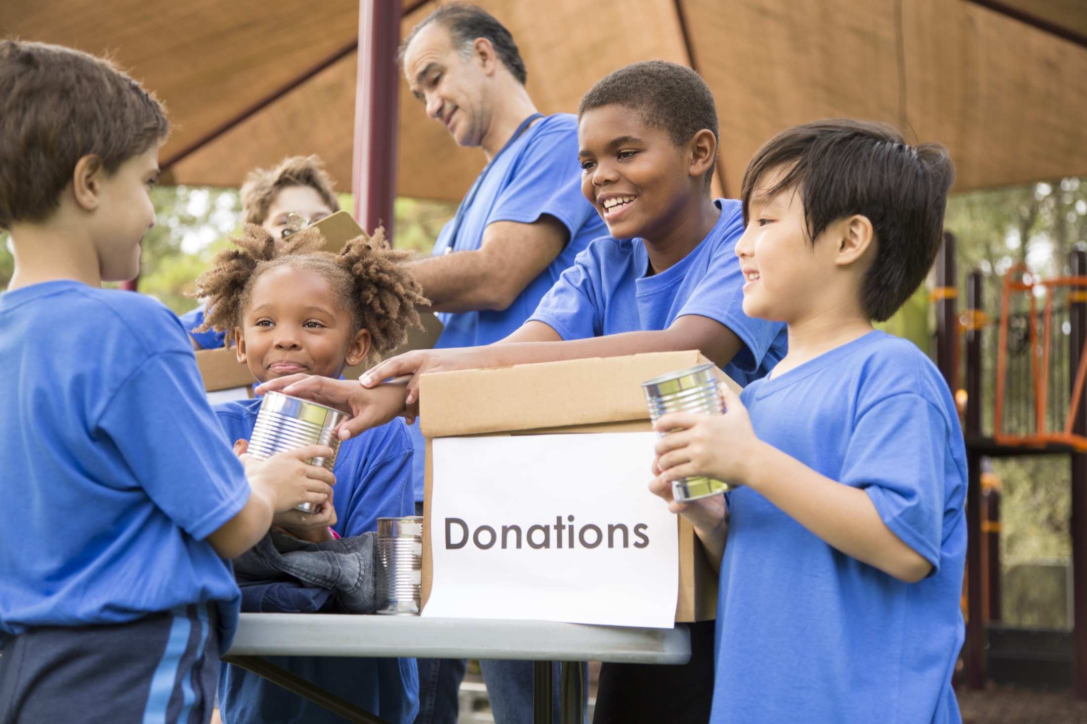 Children collecting canned food donations at a community drive